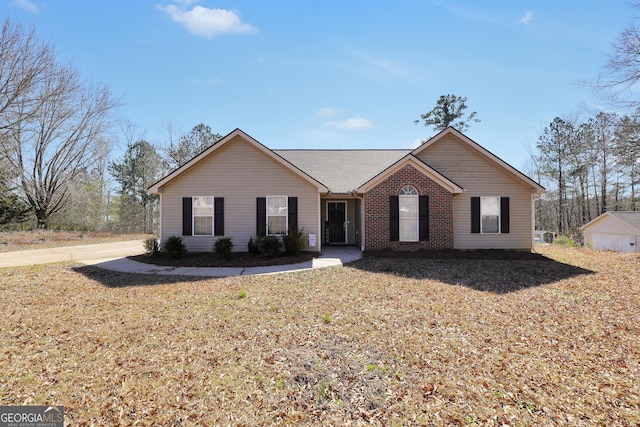 single story home with brick siding and a front lawn