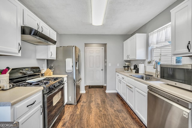 321 Harris Ave, Locust Grove, GA 30248 - kitchen featuring appliances with stainless steel finishes, under cabinet range hood, a sink, dark wood-style flooring, and white cabinets