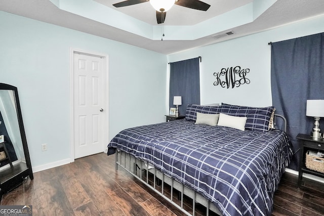 321 Harris Ave, Locust Grove, GA 30248 - bedroom with wood finished floors, baseboards, a raised ceiling, and ceiling fan