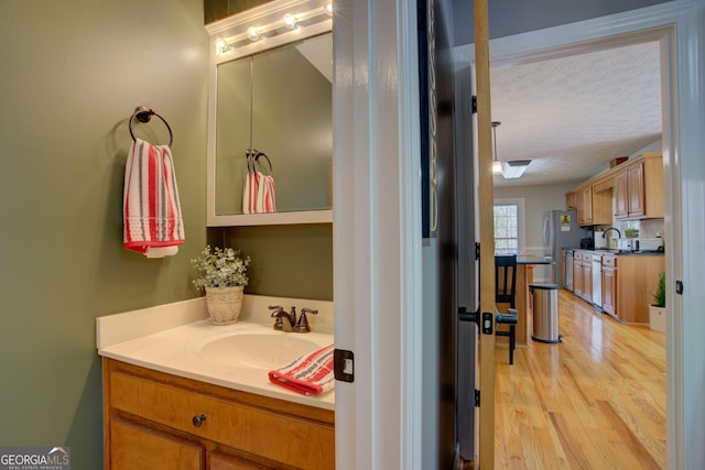 bathroom featuring vanity, wood finished floors, and a textured ceiling