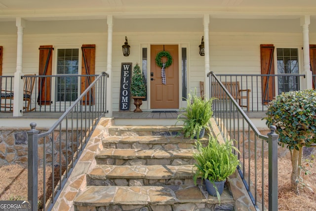 view of exterior entry with covered porch