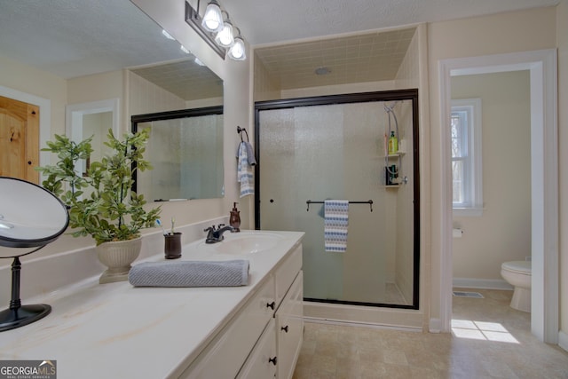 full bath with visible vents, toilet, a shower stall, and vanity