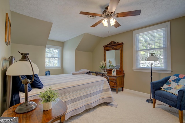 bedroom featuring carpet flooring, a textured ceiling, baseboards, and ceiling fan