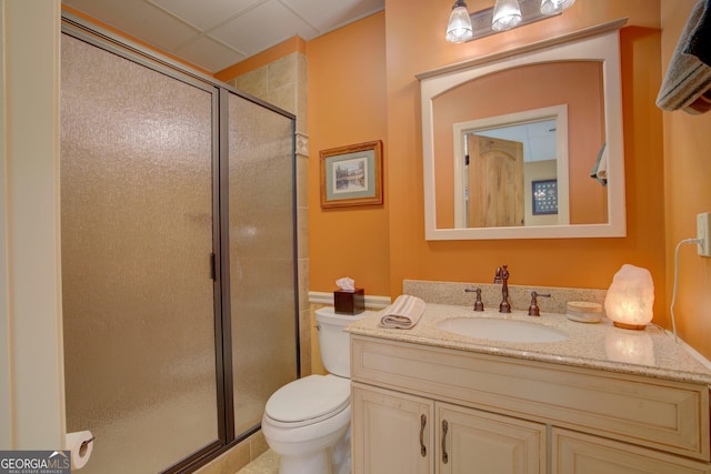 bathroom with a shower stall, vanity, and toilet