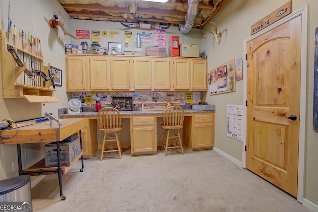 office space with baseboards and a workshop area