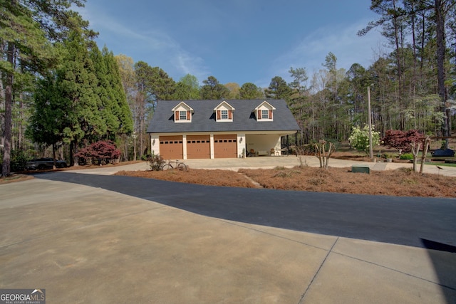 view of front of property with a garage and concrete driveway