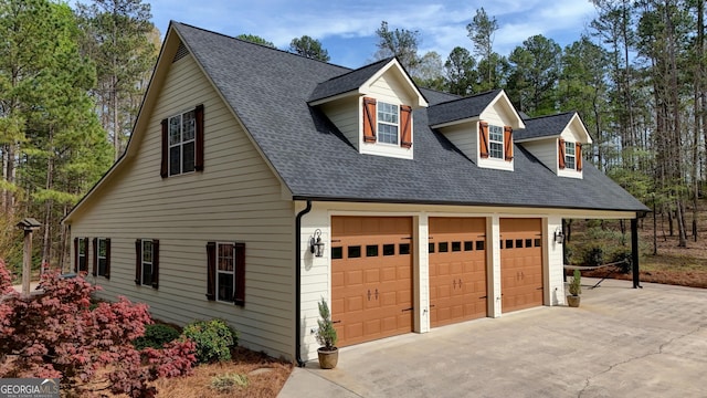 garage featuring concrete driveway