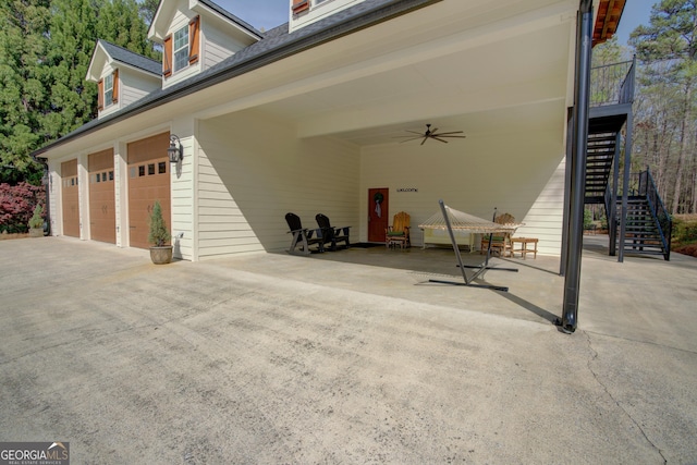 exterior space featuring concrete driveway and a ceiling fan