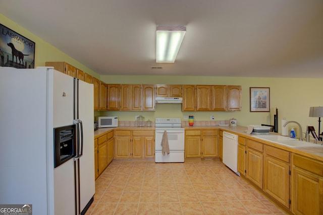 kitchen featuring light tile patterned floors, a sink, light countertops, white appliances, and under cabinet range hood
