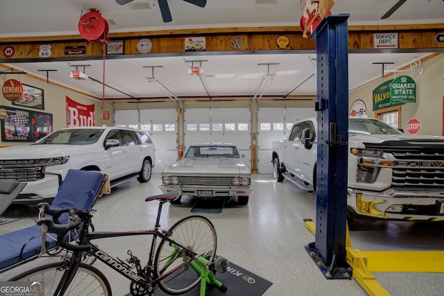 garage with a garage door opener and ceiling fan