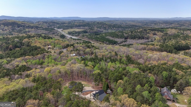 birds eye view of property with a view of trees and a mountain view