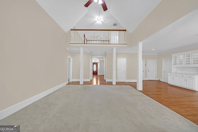 1405 Wilmington Way, Grayson, GA 30017 - unfurnished living room with a ceiling fan, high vaulted ceiling, wood finished floors, decorative columns, and crown molding