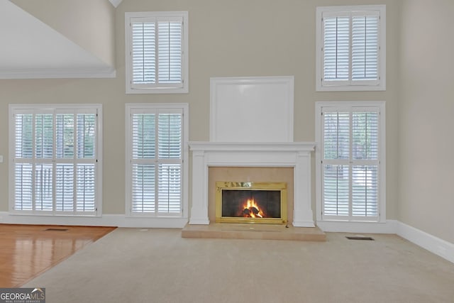 1405 Wilmington Way, Grayson, GA 30017 - unfurnished living room featuring a high ceiling, carpet floors, and a glass covered fireplace