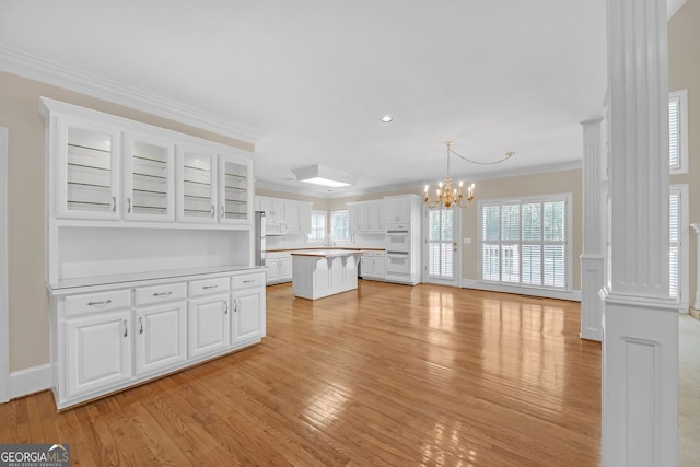 1405 Wilmington Way, Grayson, GA 30017 - unfurnished living room featuring light wood-style flooring, a chandelier, crown molding, and recessed lighting