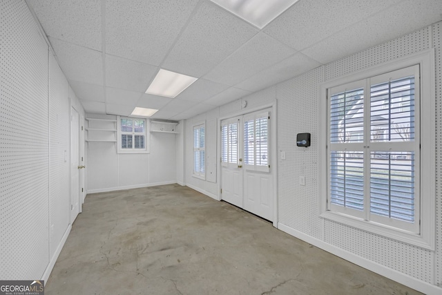 1405 Wilmington Way, Grayson, GA 30017 - foyer entrance featuring unfinished concrete floors, healthy amount of natural light, and a paneled ceiling