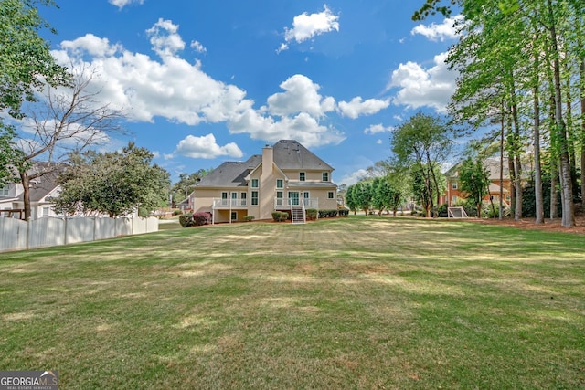 1405 Wilmington Way, Grayson, GA 30017 - back of house featuring stucco siding and a chimney
