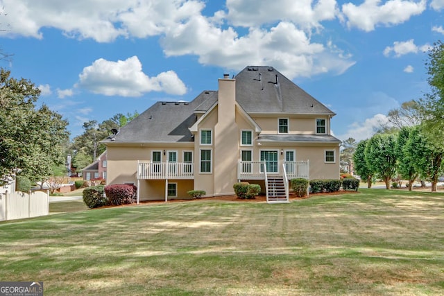 1405 Wilmington Way, Grayson, GA 30017 - rear view of house with stucco siding, a lawn, a chimney, stairs, and a deck