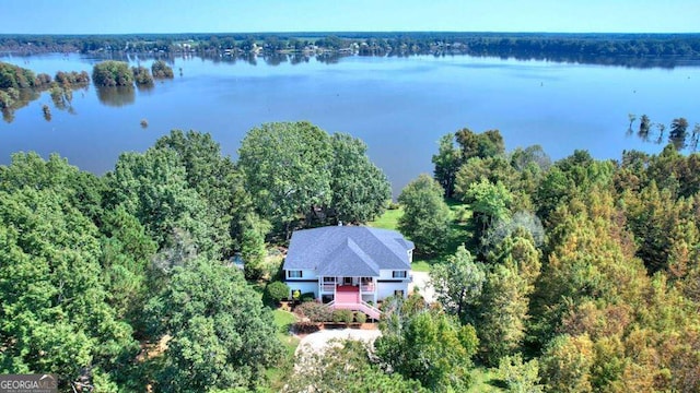 aerial view featuring a water view and a wooded view