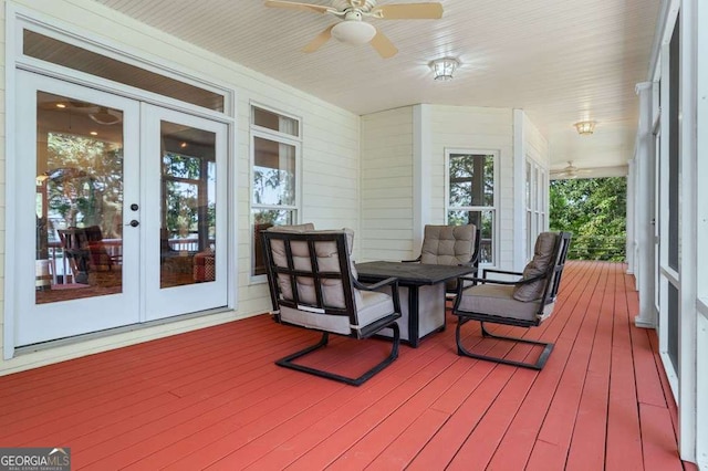 sunroom / solarium featuring french doors
