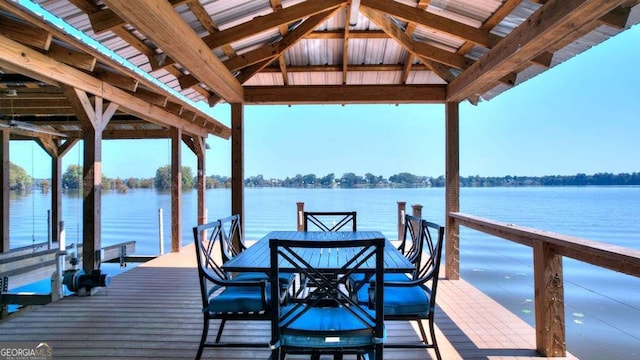 dock area with boat lift and a water view