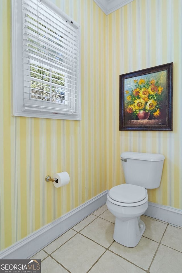 bathroom with baseboards, tile patterned flooring, and wallpapered walls