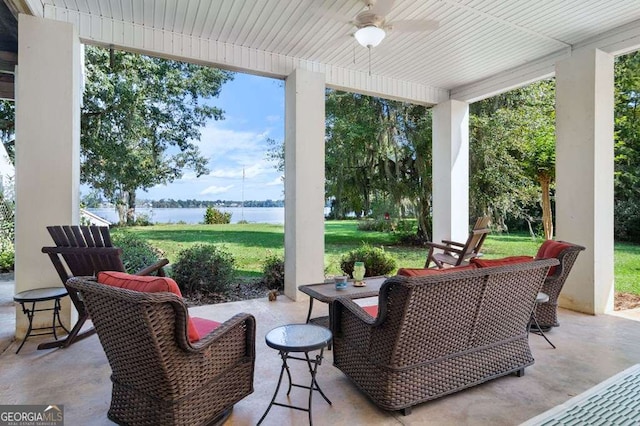 view of patio / terrace featuring a ceiling fan and a water view
