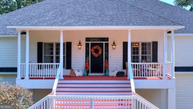 property entrance featuring a porch and a shingled roof
