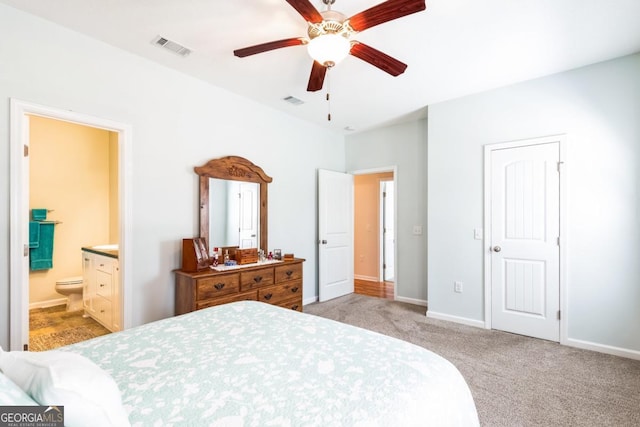 bedroom featuring ensuite bathroom, baseboards, visible vents, and carpet floors