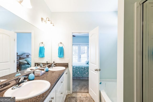 ensuite bathroom featuring a sink and connected bathroom