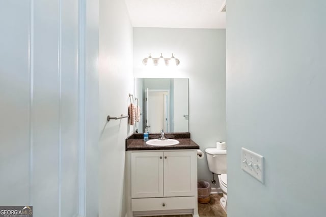 bathroom with toilet and vanity