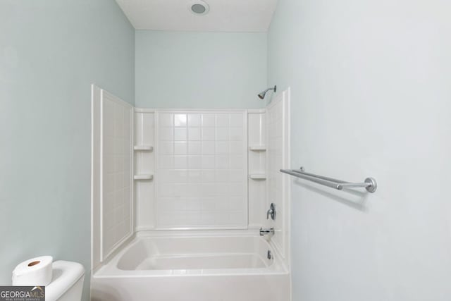 bathroom with toilet and shower / washtub combination