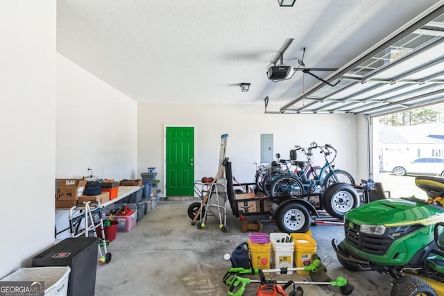 garage with a garage door opener and electric panel