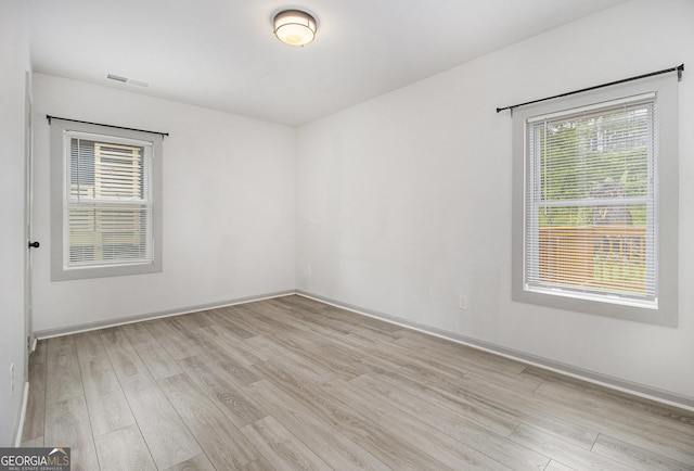609 Spring St, Atlanta, GA 30354 - empty room featuring light wood-style flooring, plenty of natural light, and baseboards