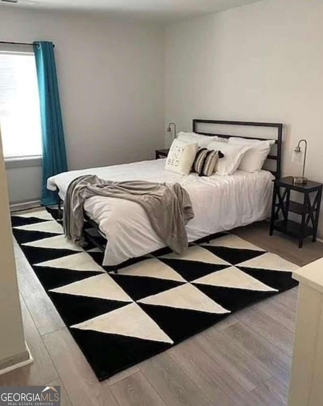 bedroom with wood finished floors