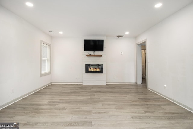 609 Spring St, Atlanta, GA 30354 - unfurnished living room featuring a large fireplace, recessed lighting, light wood-style flooring, and baseboards