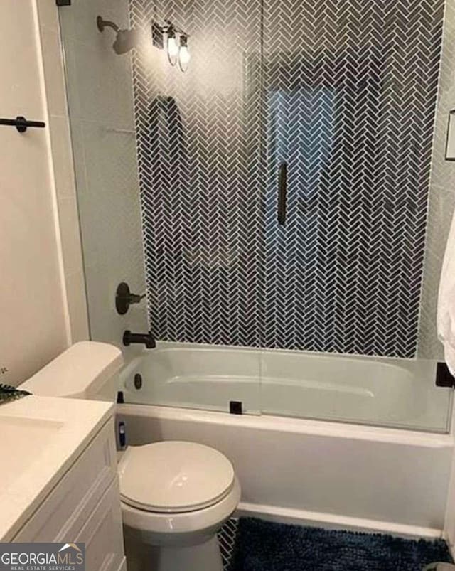 full bathroom with toilet, vanity, and shower / bath combination with glass door