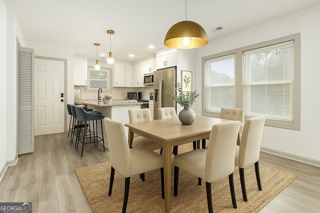 609 Spring St, Atlanta, GA 30354 - dining space with light wood-type flooring, recessed lighting, and baseboards