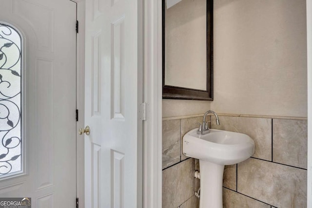 bathroom with tile walls