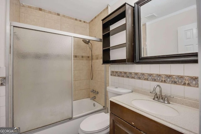 full bath featuring tasteful backsplash, visible vents, toilet, tile walls, and shower / bath combination with glass door