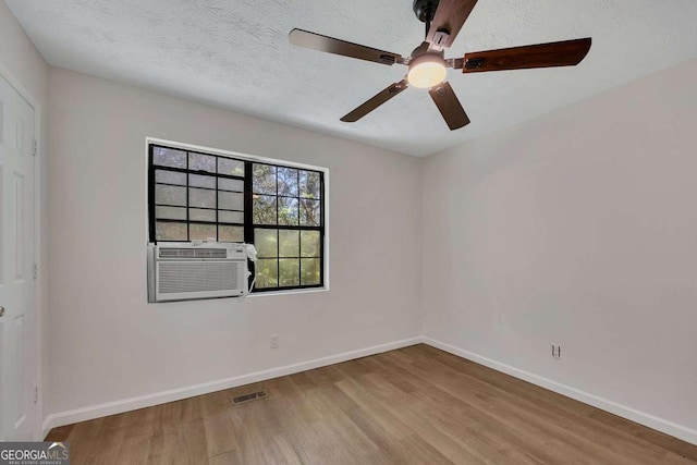 unfurnished room featuring visible vents, baseboards, a ceiling fan, and wood finished floors