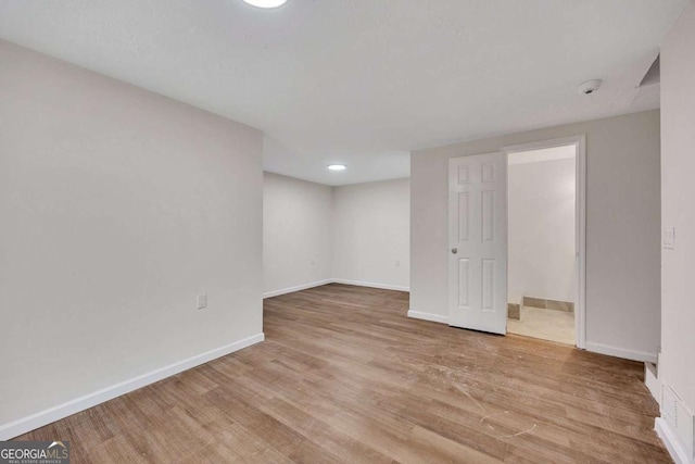 finished below grade area featuring light wood-style flooring and baseboards