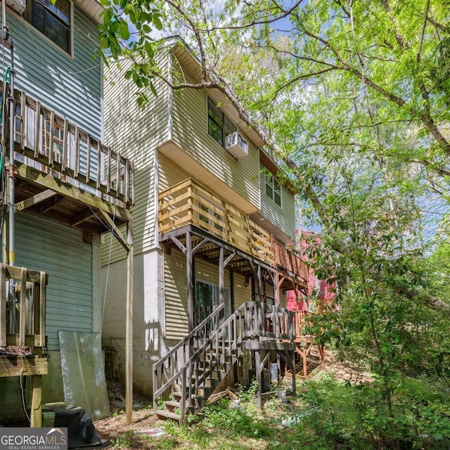 rear view of property featuring stairway
