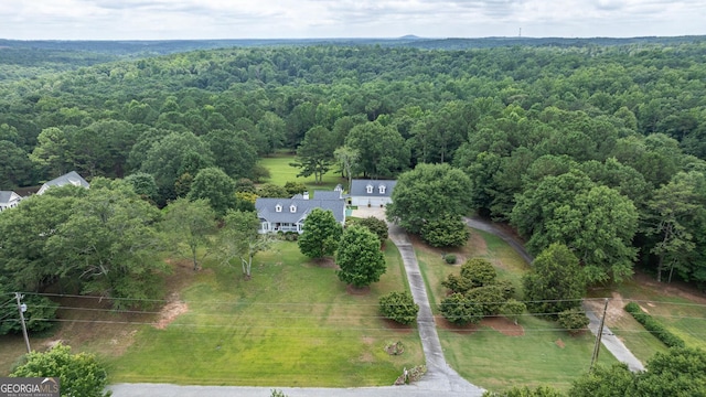 drone / aerial view featuring a wooded view