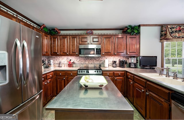 kitchen with a sink, light countertops, tasteful backsplash, and appliances with stainless steel finishes