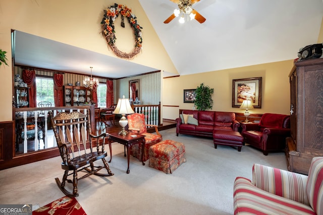 living area with carpet floors, high vaulted ceiling, and ceiling fan with notable chandelier
