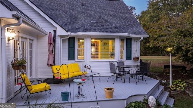 view of patio with outdoor dining space and a wooden deck