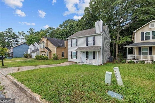 view of front of house featuring central air condition unit, a chimney, a front lawn, and covered porch