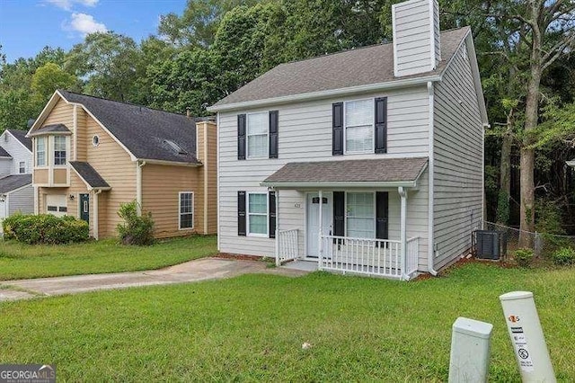 view of front of home featuring a front yard, central air condition unit, a chimney, and covered porch