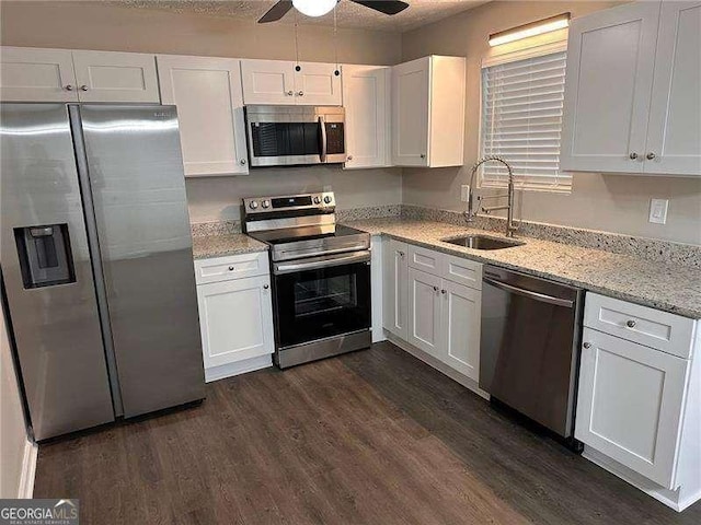 kitchen featuring a sink, dark wood-style floors, white cabinets, and stainless steel appliances