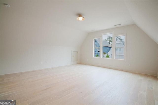 310 Arbor Garden Cir, Newnan, GA 30265 - additional living space featuring light wood finished floors, vaulted ceiling, and baseboards